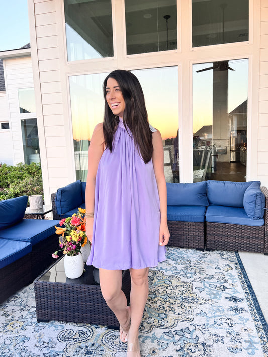 Girl wearing lavender sleeveless dress outside