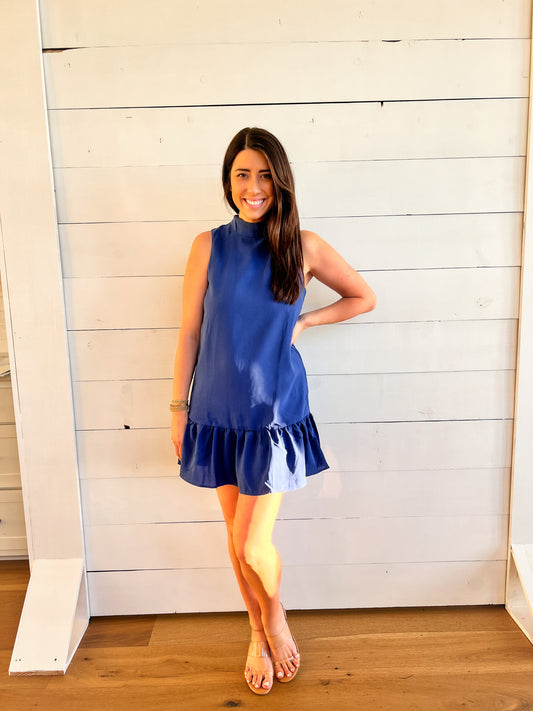 Front of high neck royal blue dress with ruffle at bottom