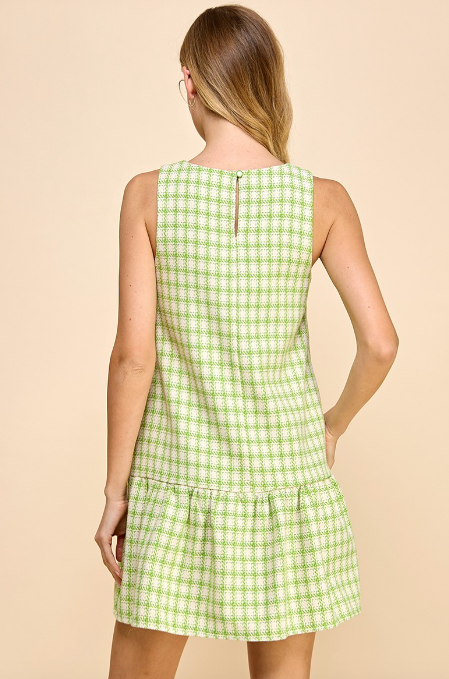 Back of green and white plaid dress with ruffle at bottom