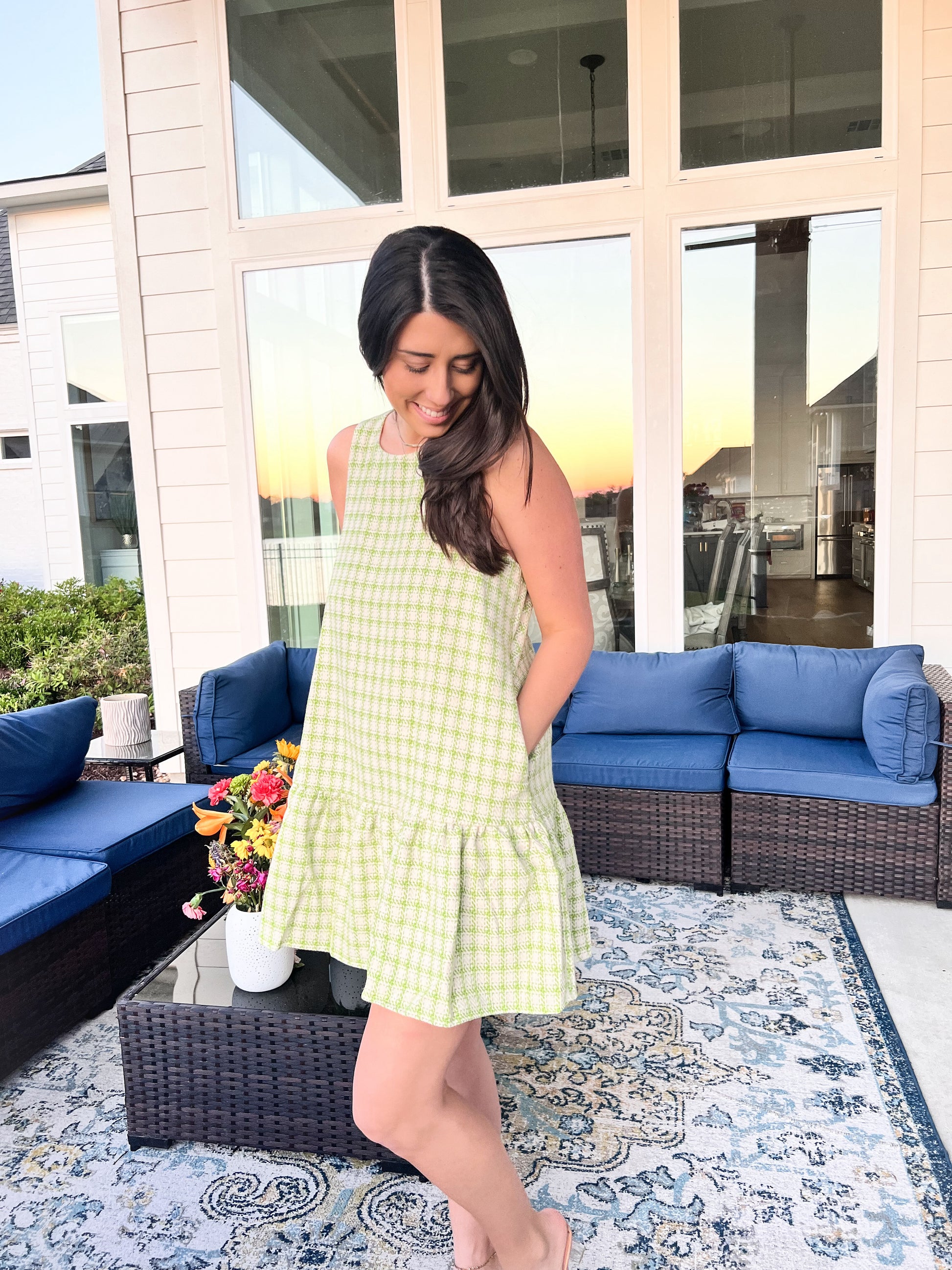 Side view of green and white plaid dress with pockets